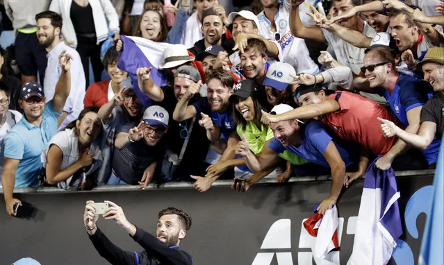 France's Benoit Paire takes selfie with his supporters as he celebrates after defeating Italy's Fabio Fognini in their second round match at the Australian Open tennis championships in Melbourne, Australia, Thursday, January 19, 2017. (Photo by Aaron Favila/AP Photo)