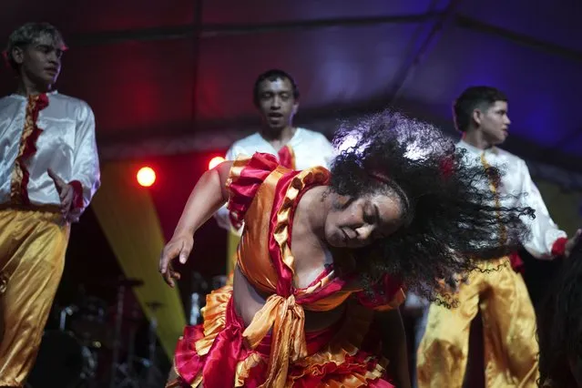 A member of the Paraguay-African cultural group Kamba Cua dances to honor Saint Balthazar, one of the Three Kings, as part of Epiphany celebrations in Fernando de la Mora, Paraguay, Saturday, January 6, 2024. (Photo by Jorge Saenz/AP Photo)