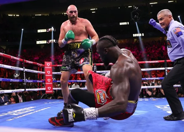 Tyson Fury (L) knocksdown Deontay Wilder (R) during their fight for the WBC heavyweight championship at T-Mobile Arena on October 09, 2021 in Las Vegas, Nevada. (Photo by Mikey Williams/Top Rank Inc via Getty Images)