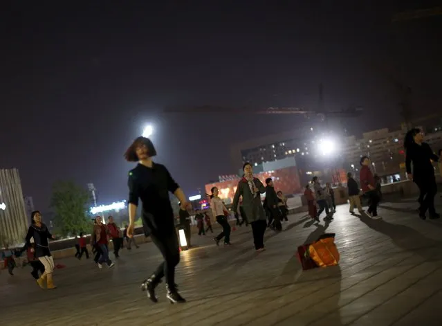 Women perform square dancing on a square in Beijing, China, April 14, 2015. (Photo by Kim Kyung-Hoon/Reuters)