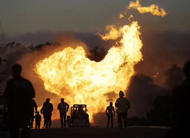In this September 9, 2010 file photo, a massive fire roars through a neighborhood in San Bruno, Calif. Pacific Gas & Electric Co. says it is prepared to pay the maximum fine of $3 million after a jury convicted the company of deliberately violating pipeline safety regulations before a deadly natural gas pipeline explosion in the San Francisco Bay Area and then misleading investigators looking into the blast. (Photo by Paul Sakuma/AP Photo)