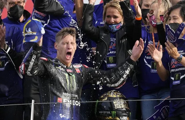 Moto GP World Champion France's rider Fabio Quartararo of the Monster Energy Yamaha MotoGP, front, celebrates on the podium with his team members after finishing fourth the MotoGP race of the Emilia Romagna Motorcycle Grand Prix at the Misano circuit in Misano Adriatico, Italy, Sunday, October 24, 2021. (Photo by Antonio Calanni/AP Photo)