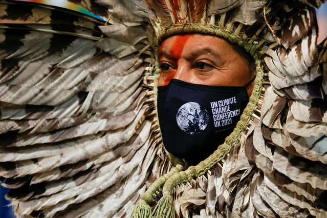 Indigenous Amazon delegate Romancil Gentil Kreta wearing a face mask of the UN Climate Change Conference (COP26) looks on during the conference in Glasgow, Scotland, Britain, November 3, 2021. (Photo by Phil Noble/Reuters)