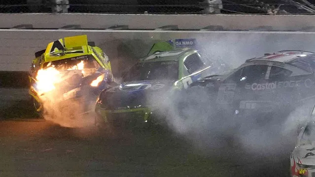 Ryan Blaney (12) catches fire after crashing along with Kyle Busch (8), and Brad Keselowski (6) during the second of two NASCAR Daytona 500 qualifying auto races Thursday, February 15, 2024, at Daytona International Speedway in Daytona Beach, Fla. (Photo by Chris O'Meara/AP Photo)