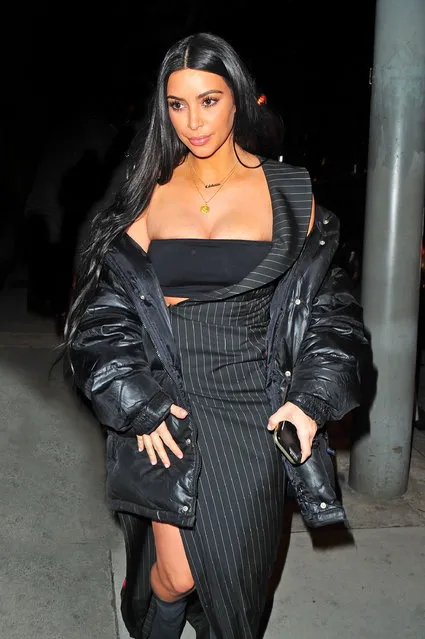 Kim Kardashian bulges out of her top and shows some leg as she heads to dinner at Craig's in Los Angeles on March 3, 2017. Kim seemed to be popped out of her top as she headed into the famous eatery. she wore a long a symmetrical dress and an oversized coat as she headed in. she seemed to be falling out of her tube top. (Photo by Fern/Mr Photoman/Splash News and Pictures)