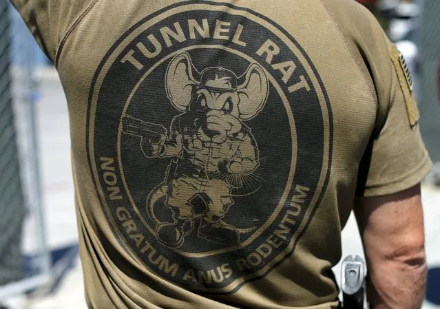 An unidentified federal officer wears a tunnel rat logo on the back of his shirt after the discovery of a cross-border tunnel between Tijuana, Mexico to Otay Mesa, California  April 20, 2016. (Photo by Mike Blake/Reuters)