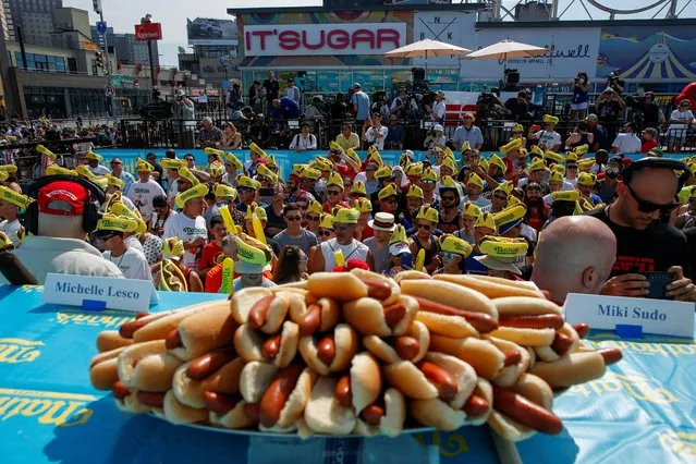 People attend the Nathan's Famous Fourth of July International Hot Dog-Eating Contest at Coney Island in Brooklyn, New York City, U.S., July 4, 2019. (Photo by Eduardo Munoz/Reuters)