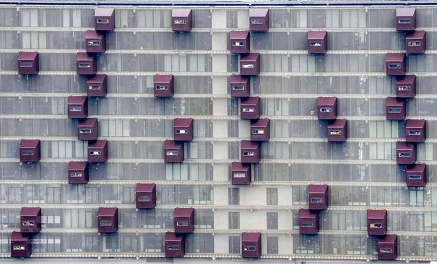 Balconies are fixed at an apartment building in the harbor of Rotterdam, Netherlands, Wednesday, July 7, 2021. (Photo by Michael Probst/AP Photo)