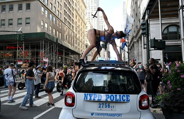 Mary Magdalene dance on top of an NYPD police car during the 29th Annual New York City Dyke March on June 26, 2021 in New York City. The Dyke March which calls itself a march protest, rather than a parade, is a “demonstration of our First Amendment right to protest” according to their website. Due to the coronavirus pandemic the march was held virtually in 2020. This year’s march began at Bryant Park and ended in Washington Square Park. (Photo by Alexi Rosenfeld/Getty Images)