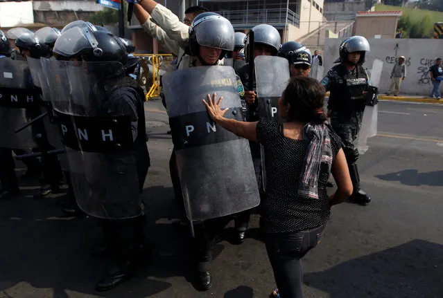 A demonstrator pushes a riot policeman during a protest to demand justice over the murder of environmental and indigenous rights activist Berta Caceres in Tegucigalpa, Honduras, May 9, 2016. (Photo by Jorge Cabrera/Reuters)