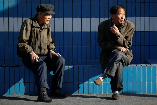 People chat in central Pyongyang, North Korea April 12, 2017. (Photo by Damir Sagolj/Reuters)