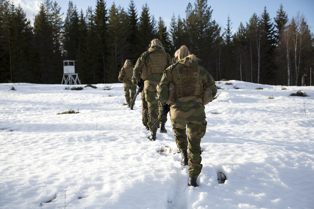 Soldiers march on the snow-covered hillside at the Terningmoen Camp in Elverum, Norway on March 23, 2017. Soldiers demonstrate their skills and tactics during a contract drill as they train to become part of the world's first all-female special forces unit, the Jegertroppen or “hunter troops”. (Photo by Carolina Reid/NBC News)