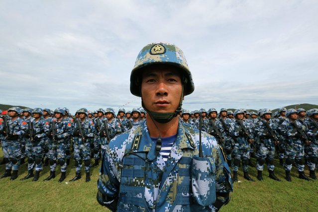 Chinese Marine Corps line up during the opening ceremony of the Blue Strike 2016 joint military exercise at a military base in Chonburi province, Thailand, 21 May 2016. Thailand and China hold joint “Blue Strike” military exercises, naval exercises focused on humanitarian relief including maritime transport, positioning training, onshore joint exercises and overall retreat. More than 700 personnel from Thailand and China are taking part in the drills, which will be held in Thailand until 09 June 2016. (Photo by Narong Sangnak/EPA)