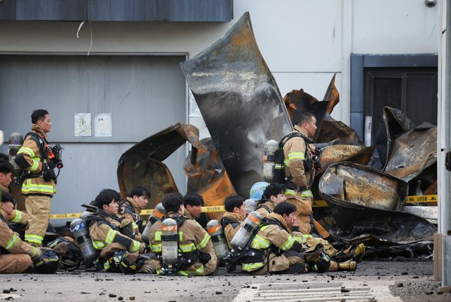 Firefighters take a break as rescue work continues following a deadly fire at a lithium battery factory owned by South Korean battery maker Aricell, in Hwaseong, South Korea, on June 24, 2024. (Photo by Kim Hong-ji/Reuters)