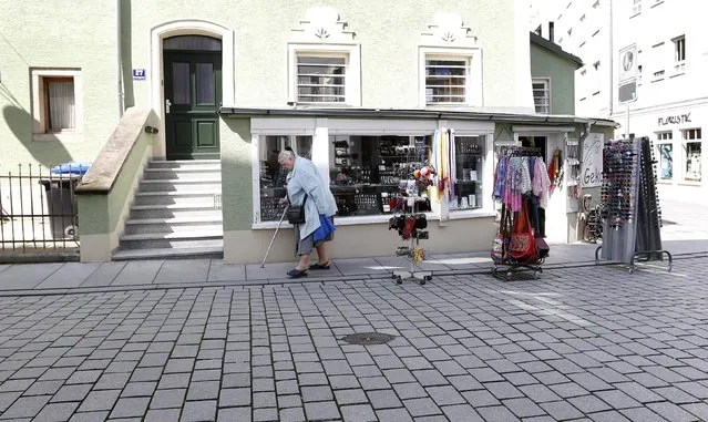 A woman passes Petra Breitenfellner's shop, "Geko", in the centre of Passau, May 19, 2014.  REUTERS/Michaela Rehle