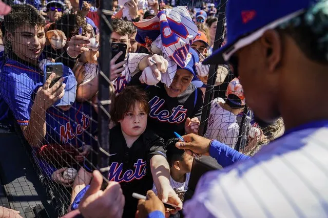 Fans ask for autographs from New York Mets shortstop Francisco Lindor before a baseball game against the Arizona Diamondbacks, Friday, April 15, 2022, in New York. (Photo by John Minchillo/AP Photo)