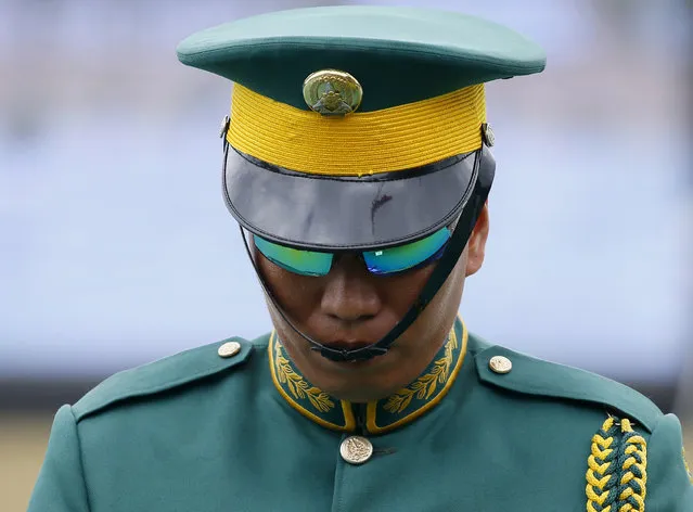 An army trooper joins a silent drill exhibition during a parade-in-review for the 120th anniversary celebration of the Philippine Army, at Fort Bonifacio in suburban Taguig city, Philippines, Tuesday, April 4, 2017. President Rodrigo Duterte threatened on Monday to unleash new attack aircraft and the “full power of the state” against communist rebels if a new round of peace talks fails, and insisted they accept new conditions including a halt to extortion and to territorial claims. (Photo by Bullit Marquez/AP Photo)