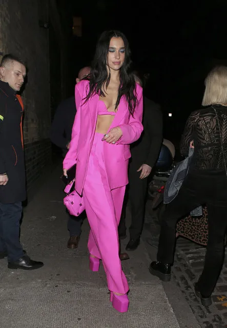 Dua Lipa seen leaving the Chiltern Firehouse with friends and family in London on May 4, 2022. The British pop star carried a studded Valentino bag and wore a hot pink outfit with matching platform heels. (Photo by The Image Direct)