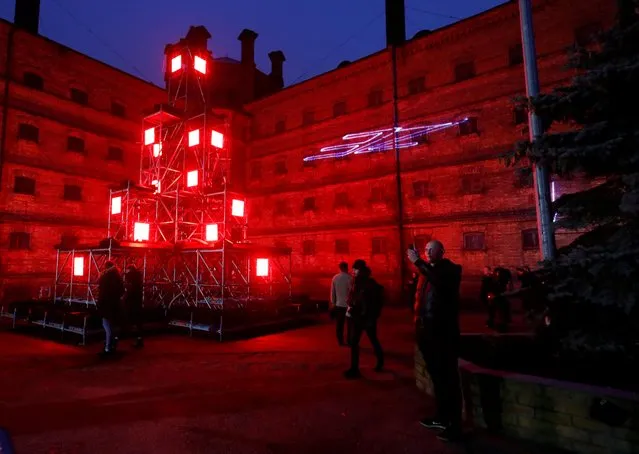 People look on light installations at the “Alternative Christmas Yard” in the former Lukiskes prison yard in Vilnius, Lithuania on December 20, 2019. (Photo by Ints Kalnins/Reuters)