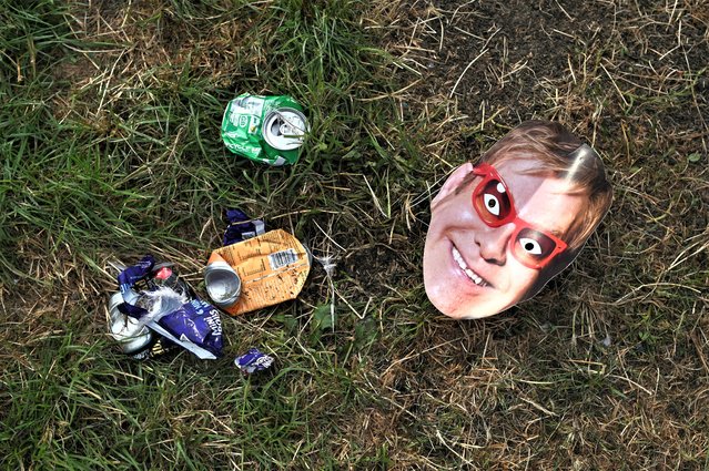 A photograph taken on June 26, 2023 shows a mask picturing British singer and musician Elton John on the ground at the end of Glastonbury festival in the village of Pilton in Somerset, southwest England. The festival takes place from June 21 to June 26. (Photo by Oli Scarff/AFP Photo)