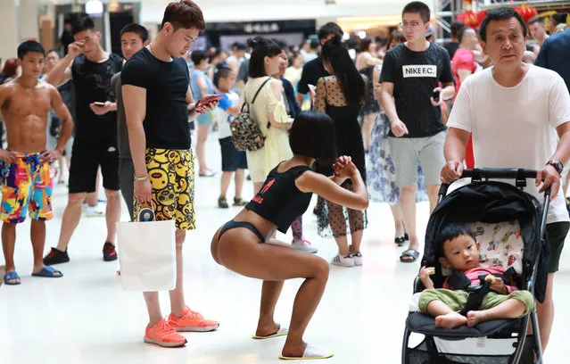 In this picture taken on June 24, 2017 participants take part in the “Women's Beautiful Buttock series” contest shopping mall in Shenyang, Liaoning province. (Photo by AFP Photo/Stringer)