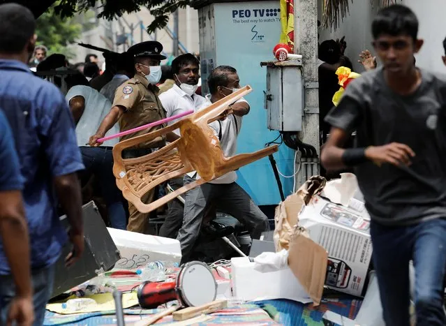 Supporters of Sri Lanka's ruling party destroy tents belonging to anti-government demonstrators, during a clash between the two groups, in front of the Prime Minister's official residence, amid the country's economic crisis, in Colombo, Sri Lanka, May 9, 2022. (Photo by Dinuka Liyanawatte/Reuters)