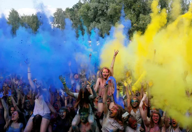 Youth throw blue and yellow powder, the colours of Ukrainian national flag, at each other during the Festival of Colours in Kiev, Ukraine, June 25, 2016. (Photo by Valentyn Ogirenko/Reuters)