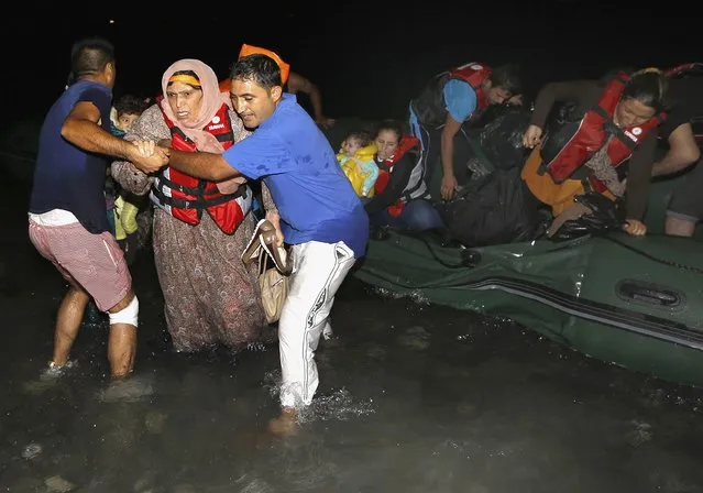 Syrian refugees arrive at a beach on the Greek island of Kos after crossing a part of the Aegean sea from Turkey to Greece on a dinghy August 13, 2015. (Photo by Yannis Behrakis/Reuters)