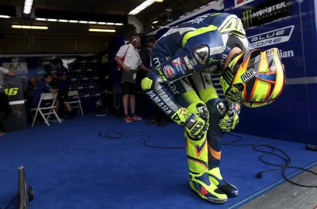 Yamaha's MotoGP rider Valentino Rossi of Italy stretches before the third free practice of the Czech Grand Prix in Brno, Czech Republic, August 15, 2015. (Photo by David W. Cerny/Reuters)