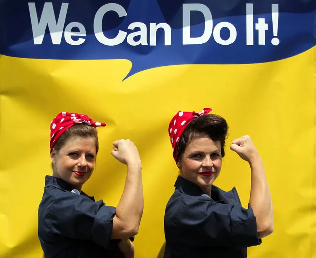 Jessica Curtis, of Long Beach, Calif., and Sarah Neller, of Vacaville, Calif., pose for a photograph in front of a “We Can Do It” backdrop as they joined with hundreds of women dressed as “Rosie the Riveter” in an attempt to set a new Guinness World Record at Rosie the Riveter/WWII Home Front National Historical Park in Richmond, Calif., Saturday, August 15, 2015. (Photo by Anda Chu/The Contra Costa Times via AP Photo)