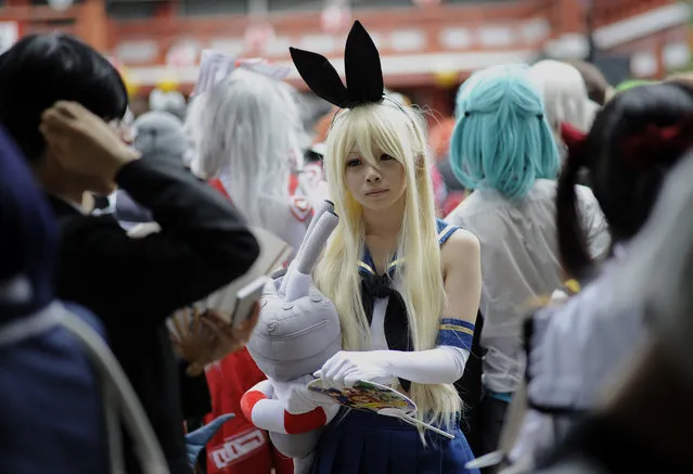 A cosplayer waits for the start of the Osu Cosplay Parade held as a part of the World Cosplay Summit (WCS) 2014 in Nagoya, central Japan, August 3, 2014. (Photo by Franck Robichon/EPA)