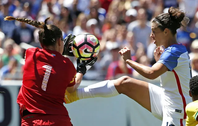 South Africa goalie Roxanne Barker, left, saves a shot by United States midfielder Carli Lloyd during the second half of the international friendly women's soccer match in Chicago, July 9, 2016. (Photo by Nam Y. Huh/AP Photo)