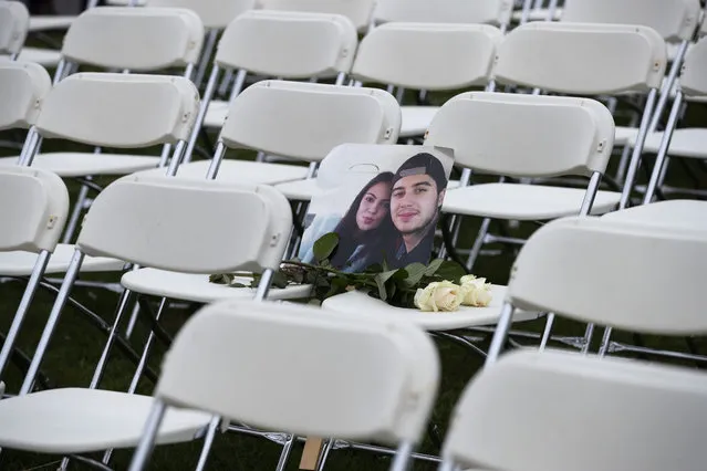 A picture of Bryce Fredriksz and his girlfriend Daisy is placed amidst 298 empty chairs, each chair for one of the 298 victims of the downed Malaysia Air flight MH17, in a park opposite the Russian embassy in The Hague, Netherlands, Sunday, March 8, 2020. A missile fired from territory controlled by pro-Russian rebels in Ukraine in 2014, tore the MH17 passenger jet apart killing all 298 people on board. United by grief across oceans and continents, families who lost loved hope that the trial which starts Monday March 9, 2020, will finally deliver them something that has remained elusive ever since: The truth. (Photo by Peter Dejong/AP Photo)