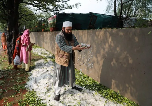 A man plays with hailstones on the side of a street after heavy rains and hailstorm in New Delhi, India, March 14, 2020. (Photo by Anushree Fadnavis/Reuters)