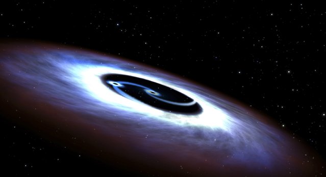 Markarian 231, a binary black hole found in the center of the nearest quasar host galaxy to Earth, is seen in a NASA illustration released August 27, 2015. Like a pair of whirling skaters, the black-hole duo generates tremendous amounts of energy that makes the core of the host galaxy outshine the glow of the galaxy's population of billions of stars, according to a NASA news release. (Photo by Reuters/NASA)