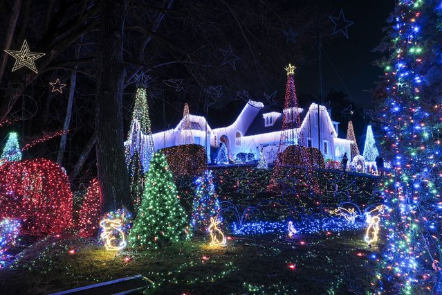 A Christmas display is seen outside of Bill Vaughn’s home on December 17, 2024 in Alexandria, Virginia. Vaughn is known for creating an elaborate holiday display until he injured himself a few years ago and has not been unable to put the show up. With less than three weeks before Christmas, Vaughn makes a return to install his display after sustaining serious injuries. (Michael A. McCoy/For The Washington Post)