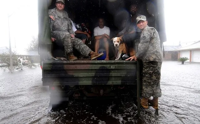 Louisiana National Guardsmen Capt. Jared Robinson and Sgt. 1st Class Steve Choat wait for more residents to make their way for rescue in the Cambridge Neighborhood in LaPlace, Louisiana on Thursday. (Photo by Arthur D. Lauck/The Advocate)