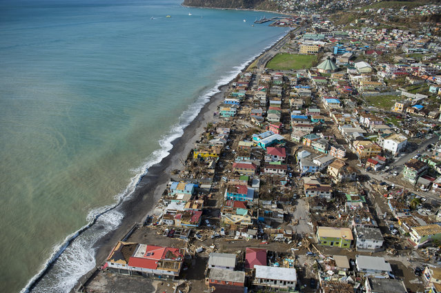 An aerial view of Roseau, capital of the Caribbean island Dominica, shows destruction September 21, 2017, three days after passage of Hurricane Maria. Dominica, located near the French islands of Martinique and Guadeloupe, has been almost completely cut off from the world since the imapact of the hurricane. (Photo by Lionel Chamoiseau/AFP Photo)