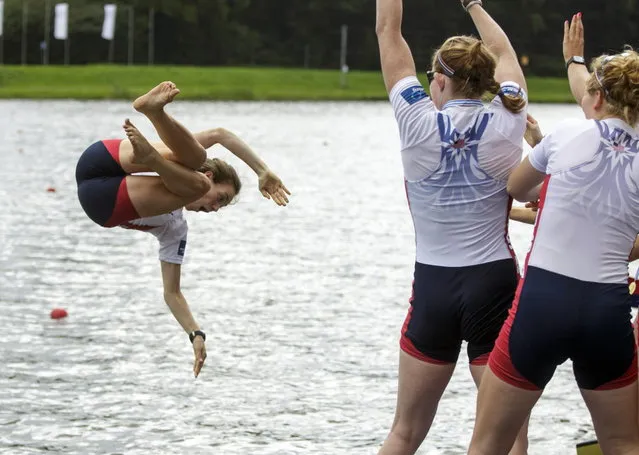 USA team cox Katelin Snyder is thrown into the water as USA team members celebrate winning, with Victoria Opitz, Meghan Musnicki, Amanda Polk, Lauren Schmetterling, Grace Luczak, Caroline Lind, Elanor Logan, Heidi Robins and Katelin Snyder of the USA, Women's Eight celebrate after winning the Final event of the World Rowing Championships in Amsterdam, Netherlands, Sunday August 31, 2014. (Photo by Phil Nijhuis/AP Photo)