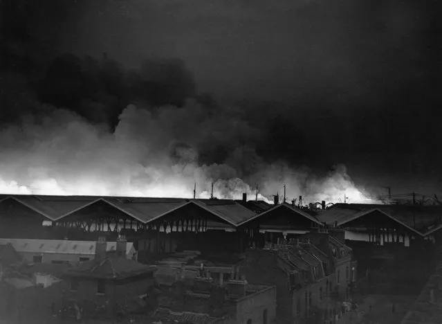Clouds of smoke reflecting fires in the East London Surrey Commercial Dock, during a heavy raid by German bombers, on the night of September 7, 1940, the initial raid of the start of the Battle Of Britain. (Photo by AP Photo/Worth)
