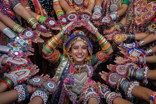 Participants from an art group wearing traditional dresses rehearse Garba dance ahead of the Navratri festival in Ahmedabad on September 20, 2022. (Photo by Sam Panthaky/AFP)