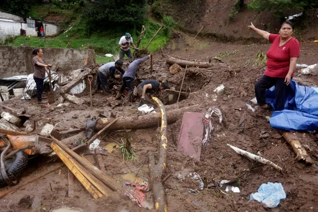 A woman gestures as residents shovel to recover belongings from their house damaged after a mudslide following heavy showers caused by the passing of Tropical Storm Earl, in the town of Huauchinango, in Puebla state, Mexico, August 7, 2016. (Photo by Reuters/Stringer)