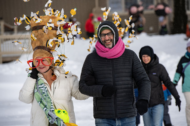 Swimmers are escorted to the pool during the Memphremagog Winter Swimming Festival at lake Memphremagog in Newport, Vermont on February 21, 2025. The event brings together cold water swimmers of all ages, the youngest being 14 and the oldest 79, to swim Olympic-style heats in near-freezing water temperatures. (Photo by Joseph Prezioso/AFP Photo)