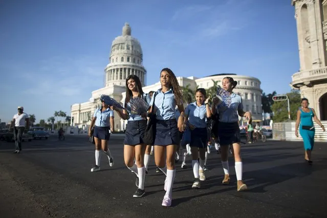 Pre-university students walk in downtown Havana to mark the first day of class for the 2015-2016 course, September 1, 2015. (Photo by Alexandre Meneghini/Reuters)