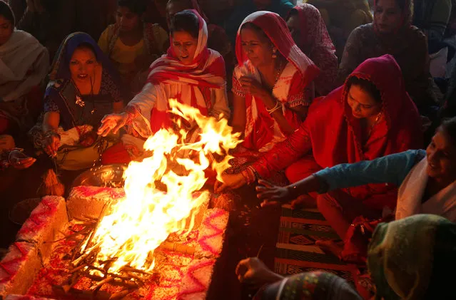 Women perform ritual in front of holy fire on the occasion of Raksha Bandhan festival at the Shri Laxmi Narayan temple in Karachi, Pakistan, August 18, 2016. (Photo by Akhtar Soomro/Reuters)