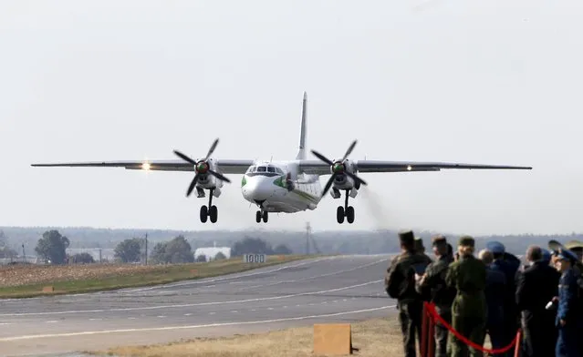 People watch as a Belarussian An-26 military jet takes off from the M1/E30 road during military exercises near the village of Krysovo, southwest of Minsk, September 23, 2015. (Photo by Vasily Fedosenko/Reuters)