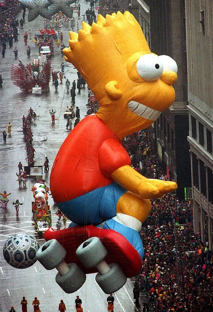 The Bart Simpson helium balloon makes a turn on his skateboard from Broadway onto 34th Street at the end of the rain drenched 66th annual Macy's Thanksgiving Day parade in New York City, Thursday, November 27, 1992.  (Photo by Bebeto Matthews/AP Photo)