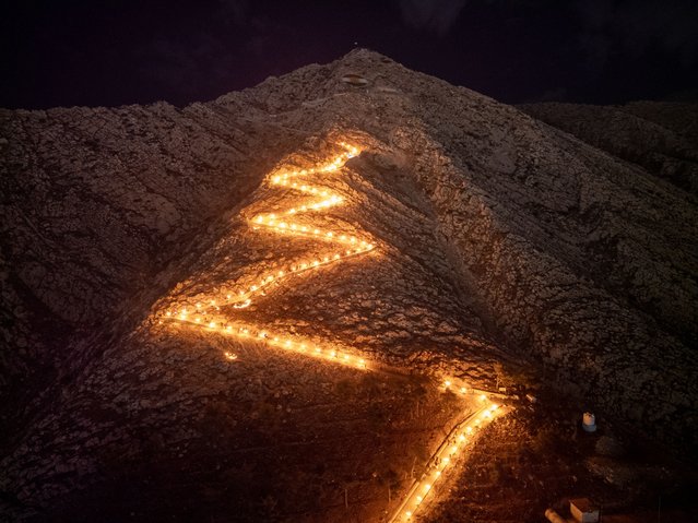 Hundreds climb Akre with torches in hands within Newroz celebrations in Duhok, Iraq on March 20, 2025. (Photo by Muhammet Bamerni/Anadolu via Getty Images)