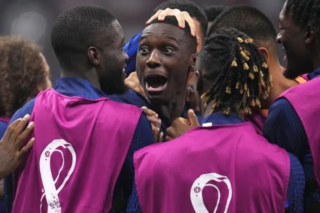 France's Randal Kolo Muani celebrates with teammates scoring his side's second goal during the World Cup semifinal soccer match between France and Morocco at the Al Bayt Stadium in Al Khor, Qatar, Wednesday, December 14, 2022. (Photo by Manu Fernandez/AP Photo)