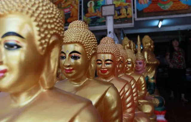 Buddha statues are seen at a shop in front of a pagoda in Phnom Penh, Cambodia, September 12, 2016. (Photo by Samrang Pring/Reuters)